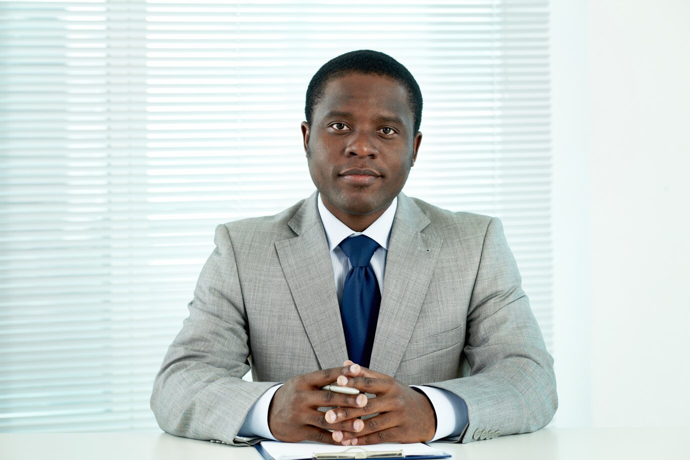 serious-executive-sitting-his-office_1098-1380